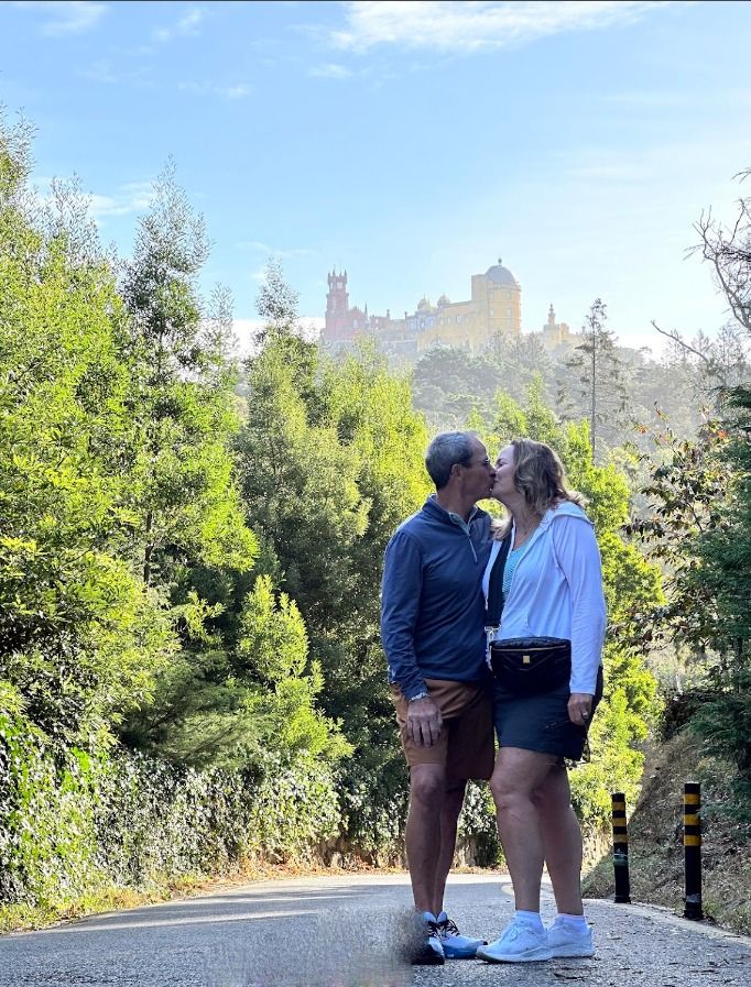 Couple viewing colorful palace on a hill.