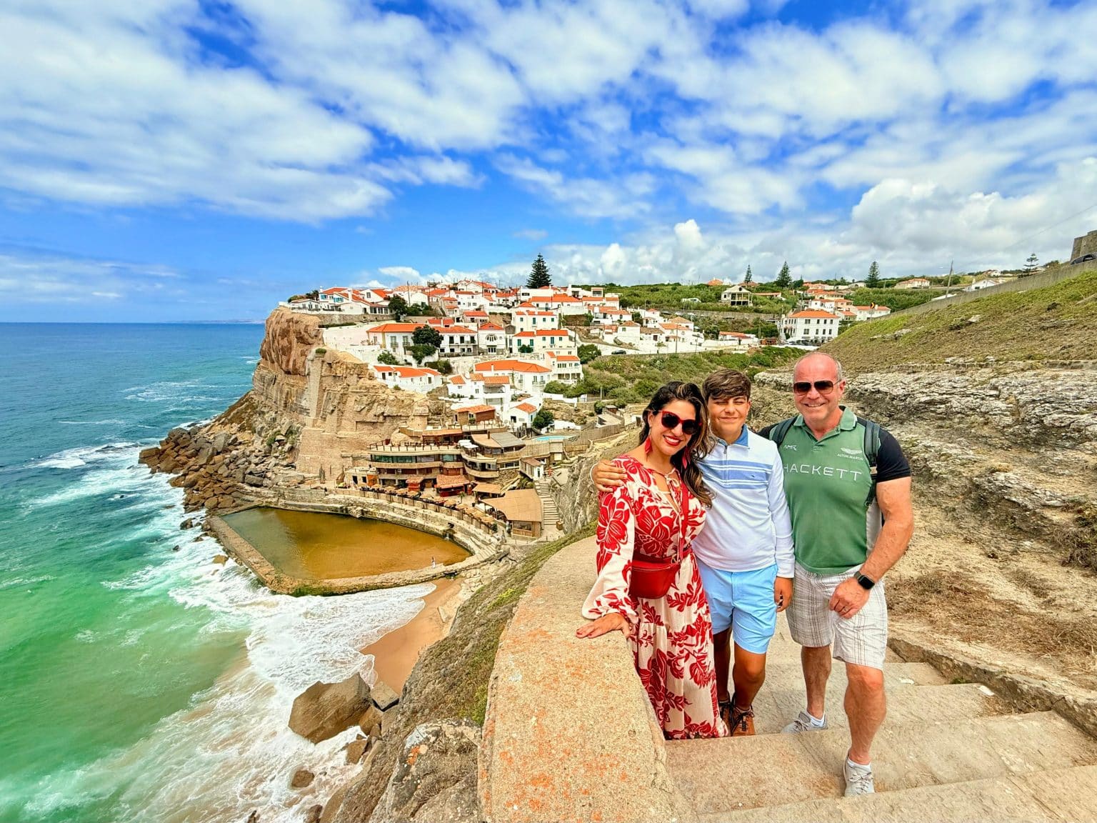 Three visitors at the Azenhas do Mar viewpoint above the Atlantic coast
