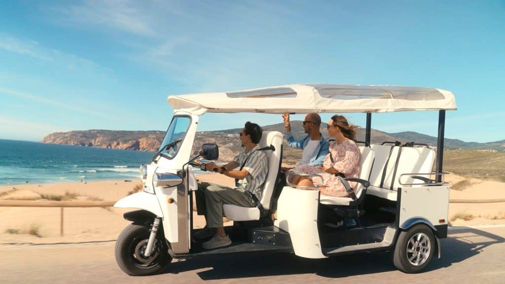 Private Sintra tuk tuk tour along the Portuguese coast with local guide and couple enjoying ocean views