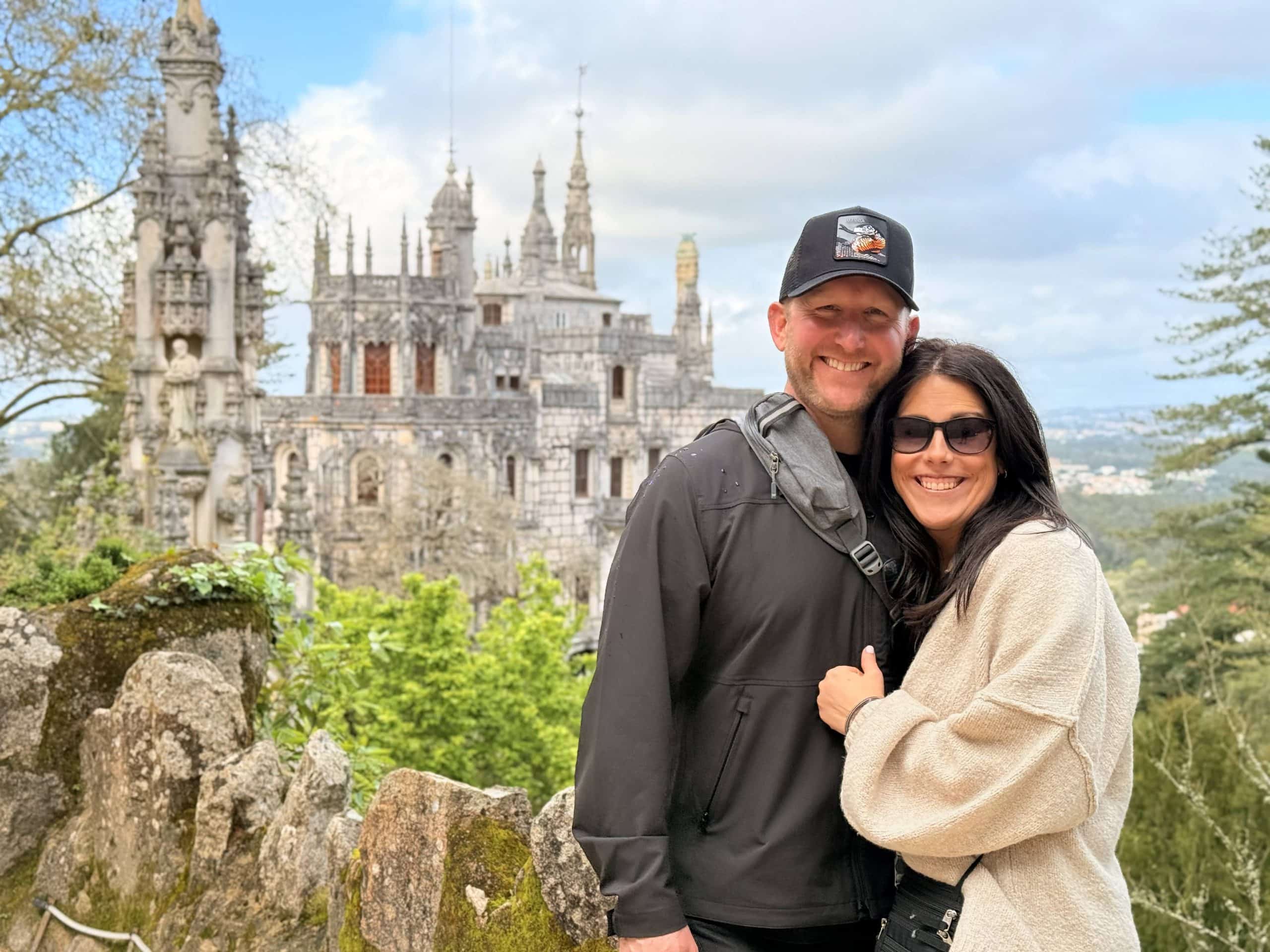 Two guests together in the gardens with Quinta da Regaleira Palace behind them