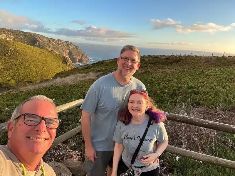 A guide and two guests overlooking the Atlantic coast