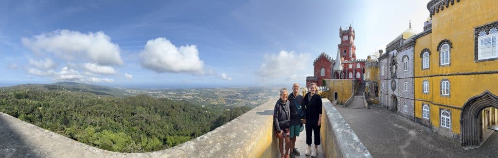 Visitors on a Pena Palace terrace overlooking the wooded Sintra hills