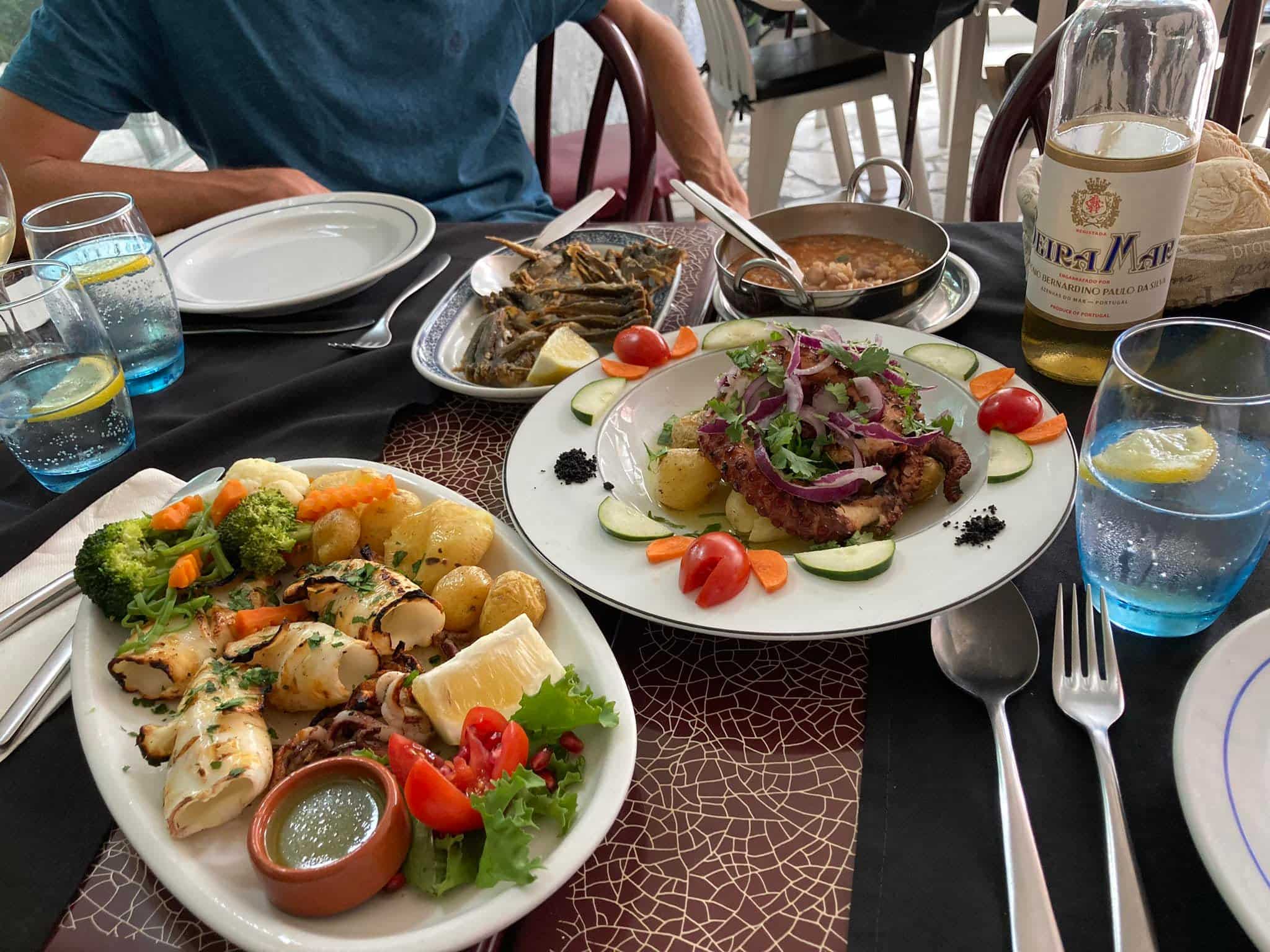 Seafood, salad and vegetables served at a Portuguese restaurant table