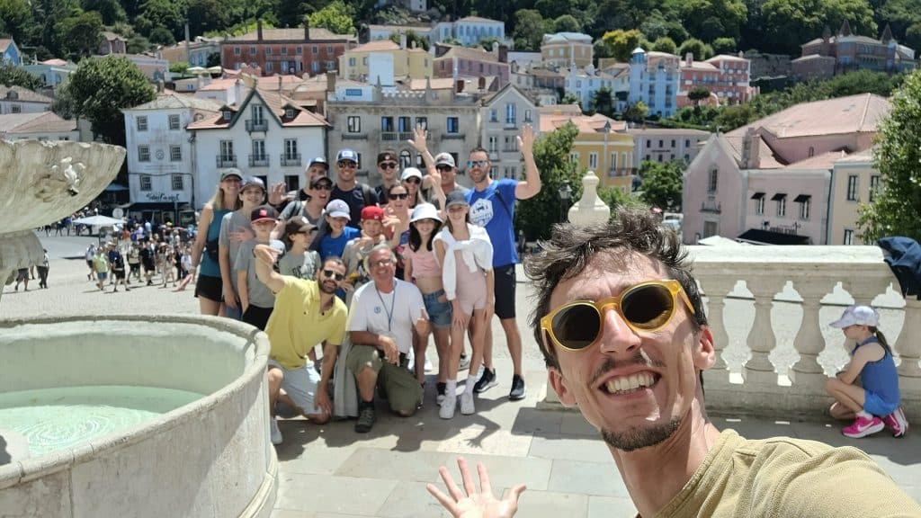 A guide and visitors posing together in Sintra town