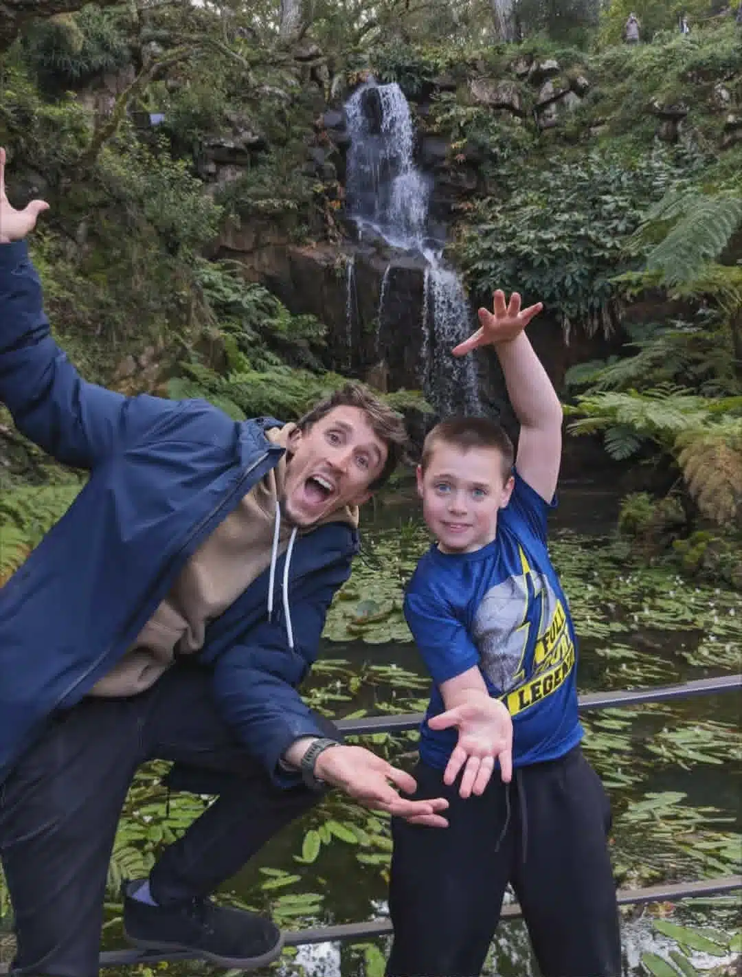 A playful guest moment beside a waterfall
