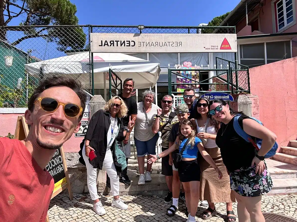 A guide and guests smiling outside a local restaurant