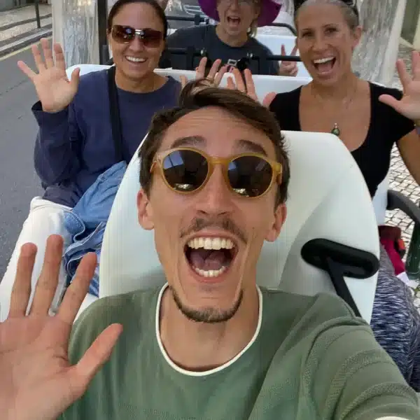 Joyful moment during a Sintra private tuk tuk tour with enthusiastic visitors and a friendly guide exploring Portugalโs hidden gems.