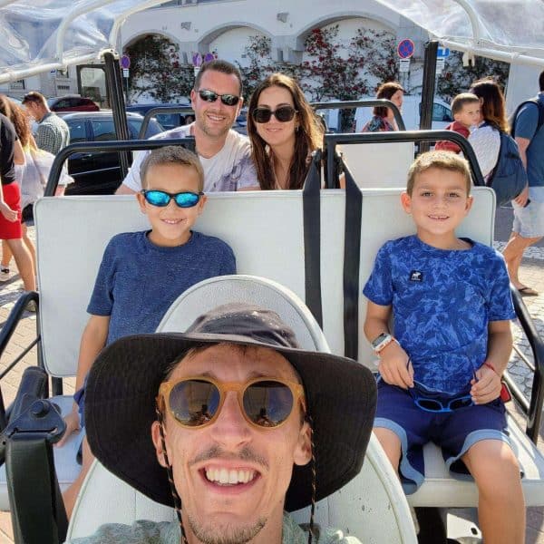 Happy family with children on a private tuk tuk tour in Sintra, Portugal, guided by Daniel Ponce from Yes, You Deserve! โ enjoying a sunny day exploring local sights and streets.