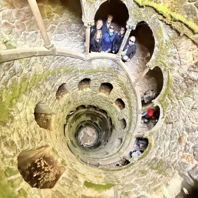 A cruise guest exploring the initiation well in quinta da regaleira in one of our tuk tuks — just 45 minutes after leaving Lisbon port.